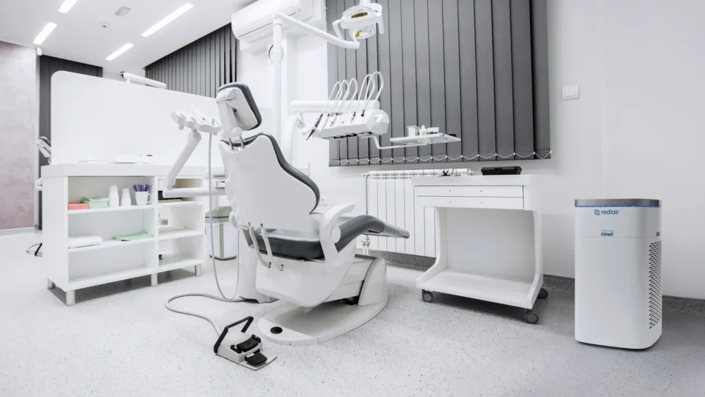 UBCS | Dental construction serivces HVAC the image showcase  A modern dental room featuring a chair and desk, designed for optimal patient care and equipped with an HVAC system.